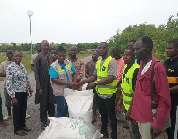 Mr Adu-Gyamfi (third from right) presenting the compost to Dr Rachel Cann