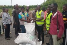 Mr Adu-Gyamfi (third from right) presenting the compost to Dr Rachel Cann