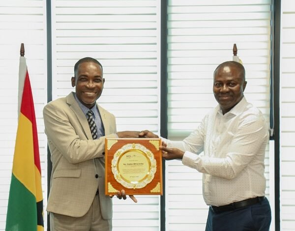 Rev Arthur (left) receiving the award from Mr Charles Appiah