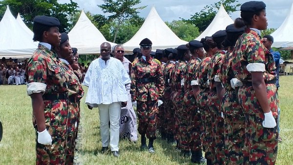Mr Nelson (in smock), Ms Arthur and Dr Adams inspecting the college cadet