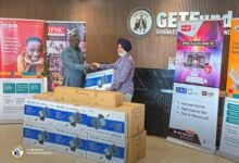 Mr Adjei (left) receiving the items from Mr Hari