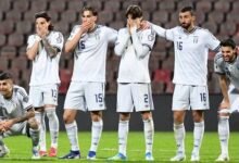 Italy players stand dejected after the penalty shout-out