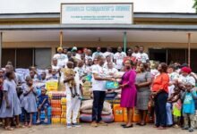 Mr Nabali (second from left, front row) presenting the items to Ms Amponsah