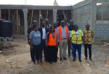 Alhaji Faila (middle) and officials of the assembly at the Pantang Basic School site