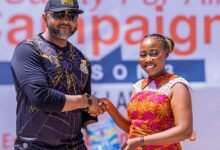 Madam Humphey presenting the first copy of her book to Mr Ampofo Ankrah