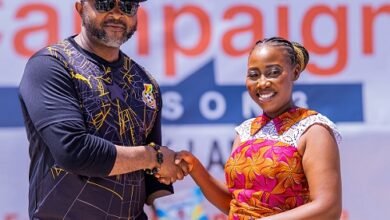 Madam Humphey presenting the first copy of her book to Mr Ampofo Ankrah