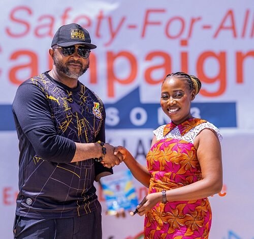 Madam Humphey presenting the first copy of her book to Mr Ampofo Ankrah