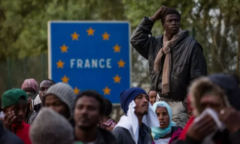 Migrants walk along the street of France