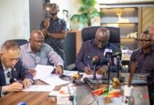 Mr Eric Opoku (second from right) and Mr. Ningquan Xu signing the MoU