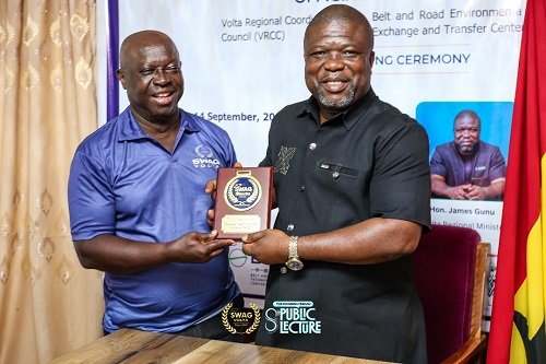Mr Kwabena Yeboah (left) presenting a plaque to Mr Gunu