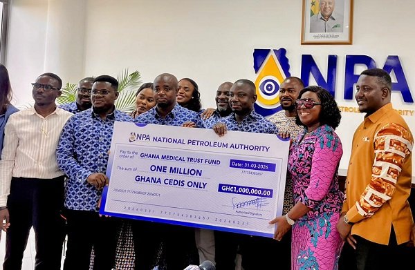 Mr Tameklo (third from left) presenting the ceremonial cheque to Ms Obuobia Darko-Opoku (second from right) and other members of both organisations present