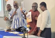 Prof Prempeh (second from left) being assisted by Mr Ellimah (second from right) to launch the report