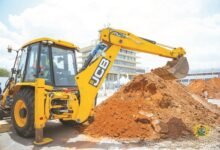President Mahama being assisted to operate the excavator machine to cut the sod for the project
