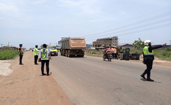 The Police inspecting vehicles on the road