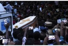 Residents film the white coffin of one of the men in Sathankulam, Tamil Nadu, in 2020