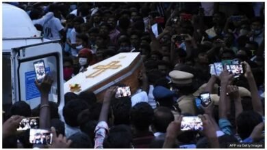 Residents film the white coffin of one of the men in Sathankulam, Tamil Nadu, in 2020