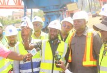 • Mr Agbodza (left) being briefed on the progress of work at the Tetteh Quarshie, Tema Motorway interchange expansion road project by Mr Ben Sackey. Photo: Ebo Gorman