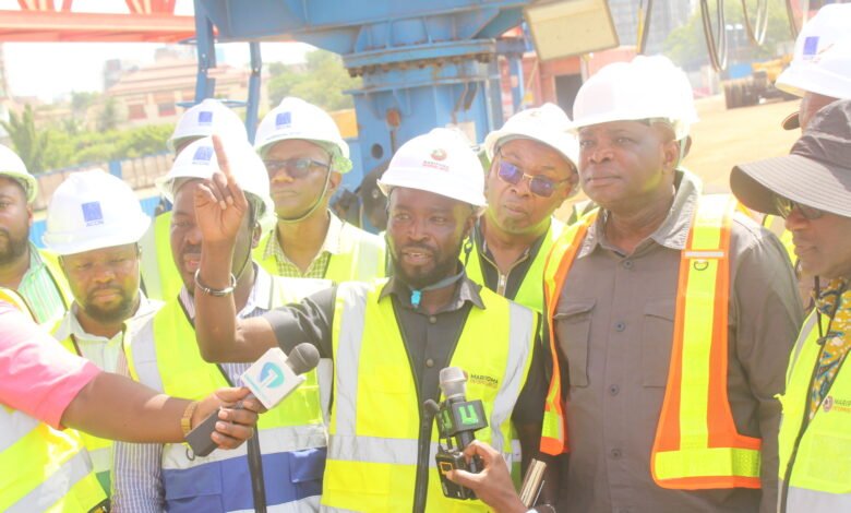 • Mr Agbodza (left) being briefed on the progress of work at the Tetteh Quarshie, Tema Motorway interchange expansion road project by Mr Ben Sackey. Photo: Ebo Gorman
