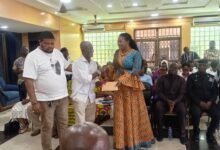 Ms Bright (right) presenting the cash to a representative of TTC