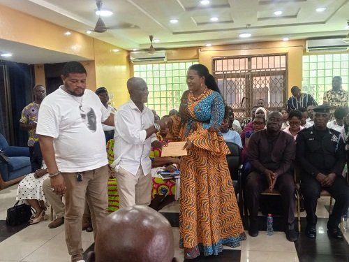 Ms Bright (right) presenting the cash to a representative of TTC