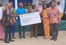 Mr Bubuama (fourth from right) receiving the cheque from Mr Samuel Aboni (right)