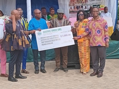 Mr Bubuama (fourth from right) receiving the cheque from Mr Samuel Aboni (right)