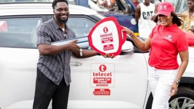 Mr Ofori-Ennin (left) receiving the key to his car from a Telecel Ghana official