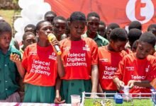 Ruth Martey explaining how the ''Smart Farm'' works at the graduation ceremony. With her are the teammates