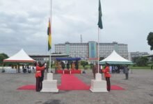 Mr Quayson (left) and Mr Chinoze hoisting the flags during the AU flag raising celebration day Photo Victor A. Buxton