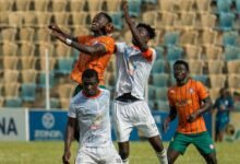 Nations' skipper, Kwame Boakye, and Kelvin Ampoful in a tussle for the ball with Benjamin Kwarteng