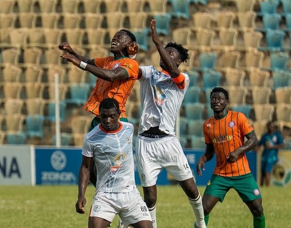Nations' skipper, Kwame Boakye, and Kelvin Ampoful in a tussle for the ball with Benjamin Kwarteng