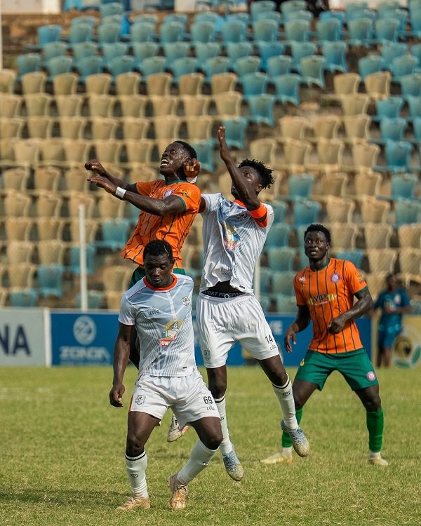 Nations' skipper, Kwame Boakye, and Kelvin Ampoful in a tussle for the ball with Benjamin Kwarteng