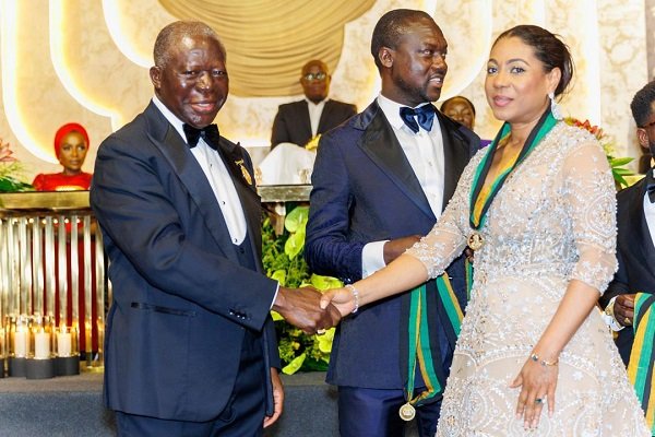 Ms List (right) in a handshake with Otumfuo Osei Tutu II, Asantehene after receiving her award