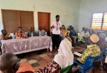 Mr Kponyo, (standing) educating GNAT members and residents in Bimbilla during the engagement