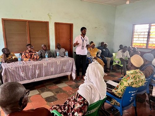 Mr Kponyo, (standing) educating GNAT members and residents in Bimbilla during the engagement