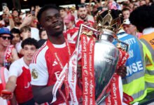 Bukayo Saka with the EPL trophy