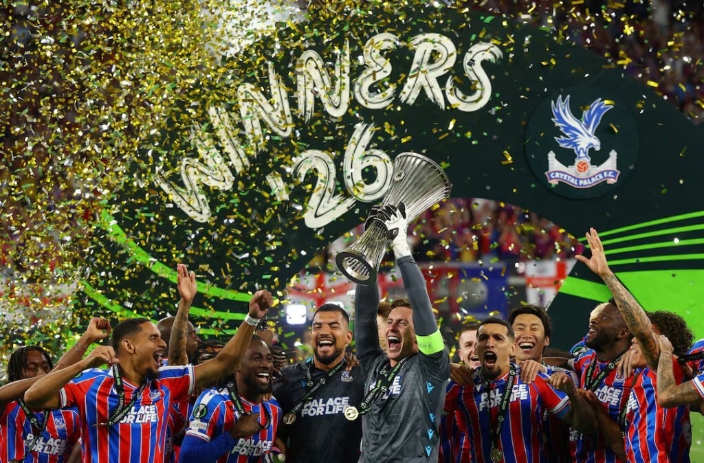 Crystal Palace's Dean Henderson lifts the trophy as he celebrates with teammates after winning
