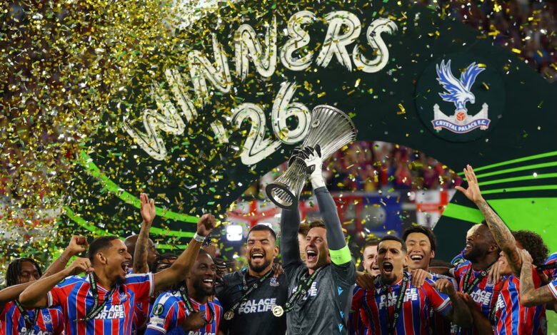 Crystal Palace's Dean Henderson lifts the trophy as he celebrates with teammates after winning