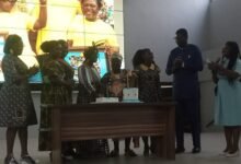 Dr Okai-Mensah (middle), together with other dignatries, cutting the anniversary cake.