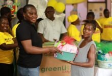 Ms Sampong (left) presenting a baby hammper to one of the nursing mothers at the Cape Coast Teaching Hospital
