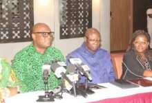 Mr Madjie (second from left) addressing the press. With him include Mr Oppong-Fosu (third from right), Board Chairman, GIPC
