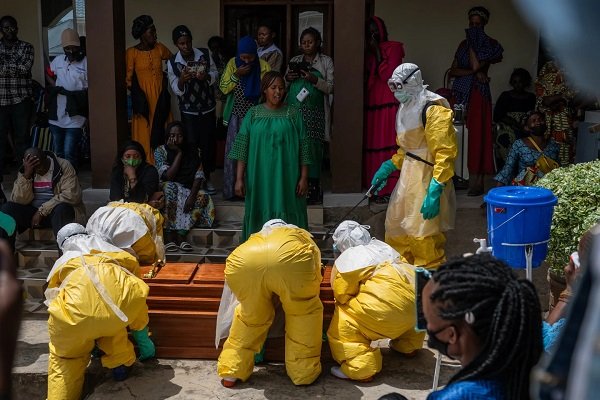 Family members of an Ebola victim mourn as the coffin is taken away for burial in Congo