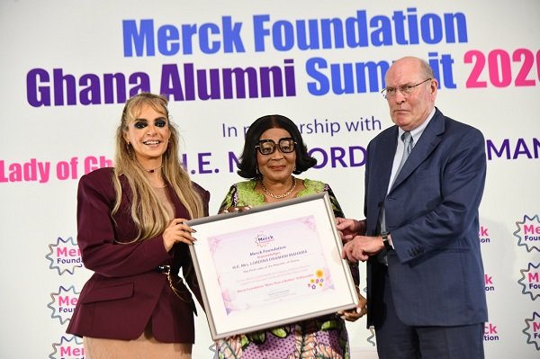 First Lady, Lordina Mahama (middle) receiving an award from officials from Merck Foundation at the ceremony