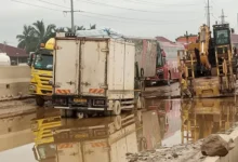 Flashback, Some trucks stuck in the muddy in the section of the Ofankor Nsawam Road