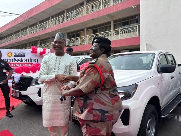 Mr Mohammed-Mubarak (left) handing over the keys of the vehicles to Chief Fire Officer, Sarpong