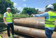 Mr Mutawakilu (righ) being briefed about the fabrication process of the pipelines during the visit