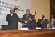 -Mr Ablakwa (second from right) and Ms Smith exchanging the signed documents Photo Victor A. Buxton