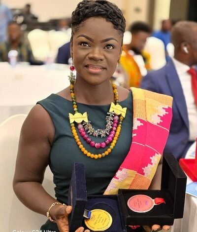 Ms Agnes Opoku Sarpong displaying her Awards