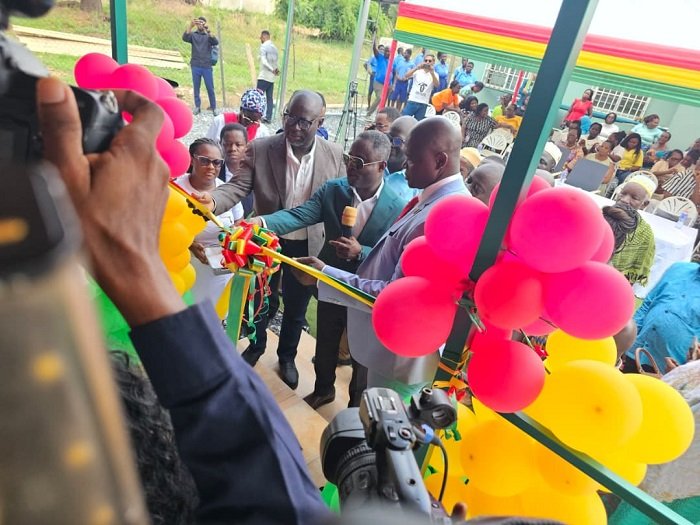 Mr Akandoh (middle) being assist by Alhaji Faila (left) to inaugurate the facility