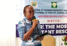Ms Awude (inset) addressing participants at the event